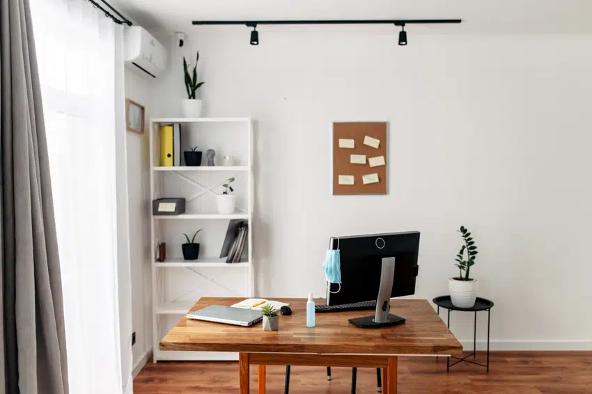 Simple wall decor for home offices with table, chair, window, track lights, and shelves