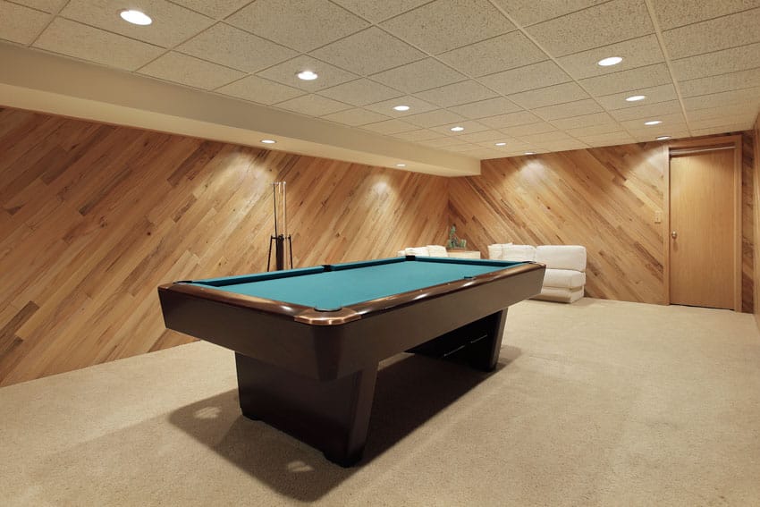 Spacious game room with pool table, diagonal wood wall, and recessed lighting fixtures