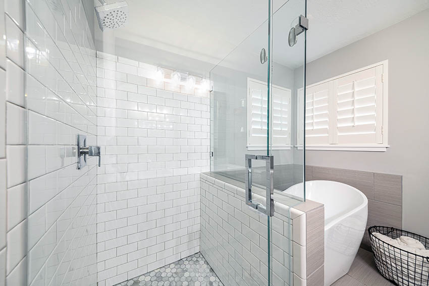 Subway tile bathroom shower with glass enclosure 