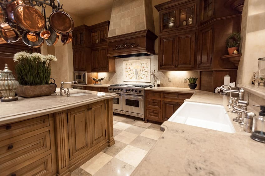 Kitchen with countertops, center island, dark wood cabinets and tile floors