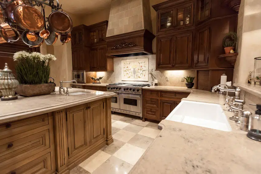 Kitchen with countertops, center island, dark wood cabinets and tile floors