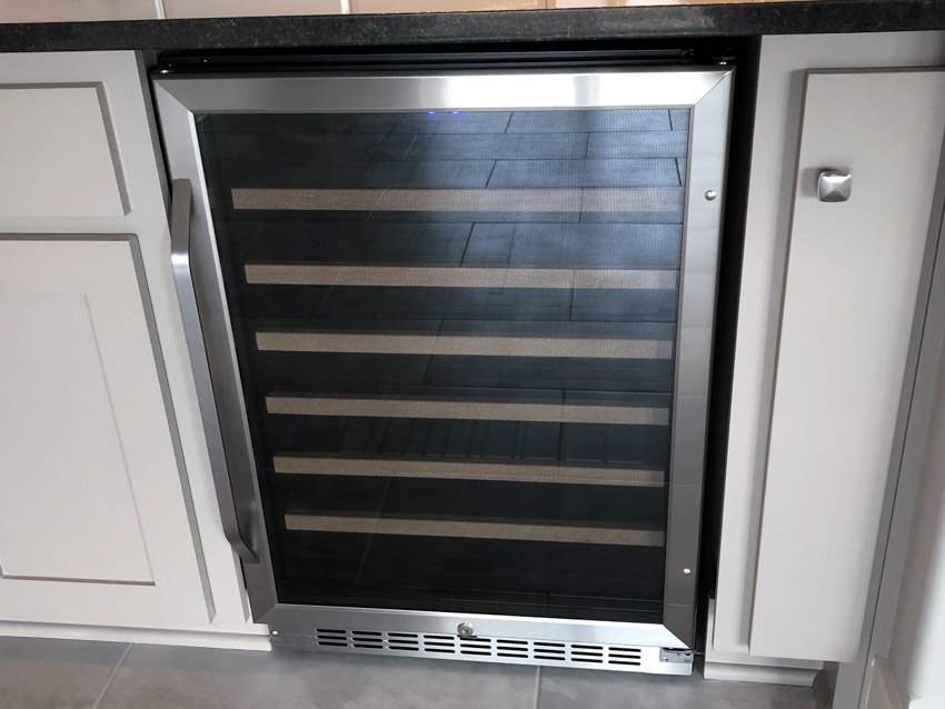 Wine cooler built into a kitchen cabinet