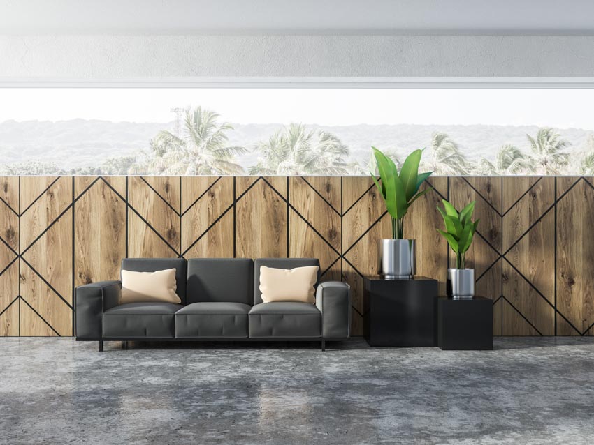 Living room with wood geometric wall, couch, and indoor plants