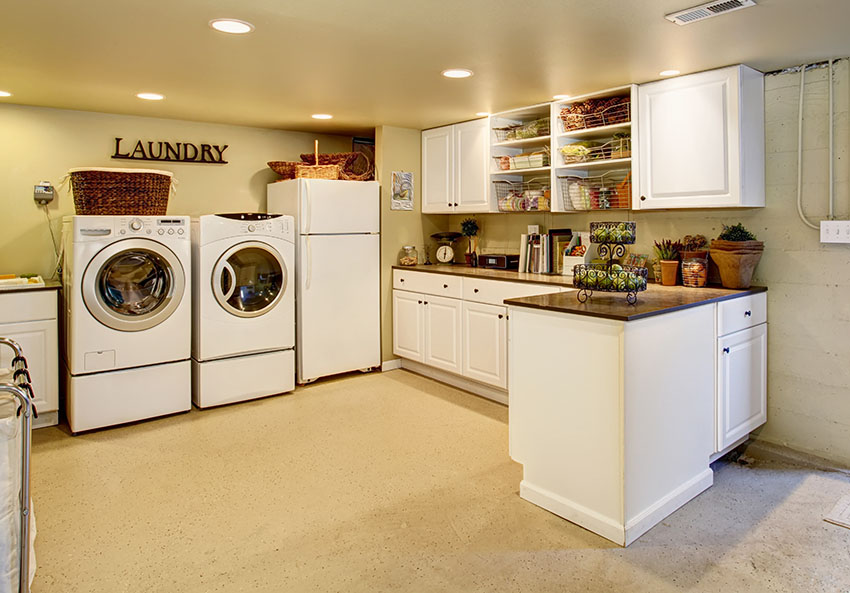 Kitchen with laundry, recessed lighting and white cabinetry