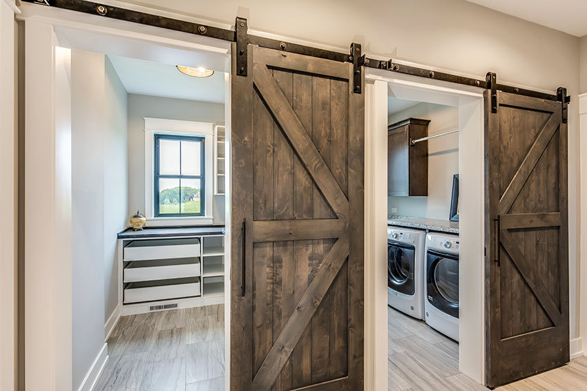 Laundry with barn doors and gray paint