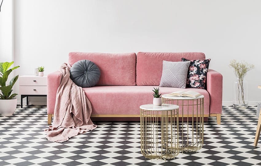 Pink loveseat with modern coffee tables black and white flooring