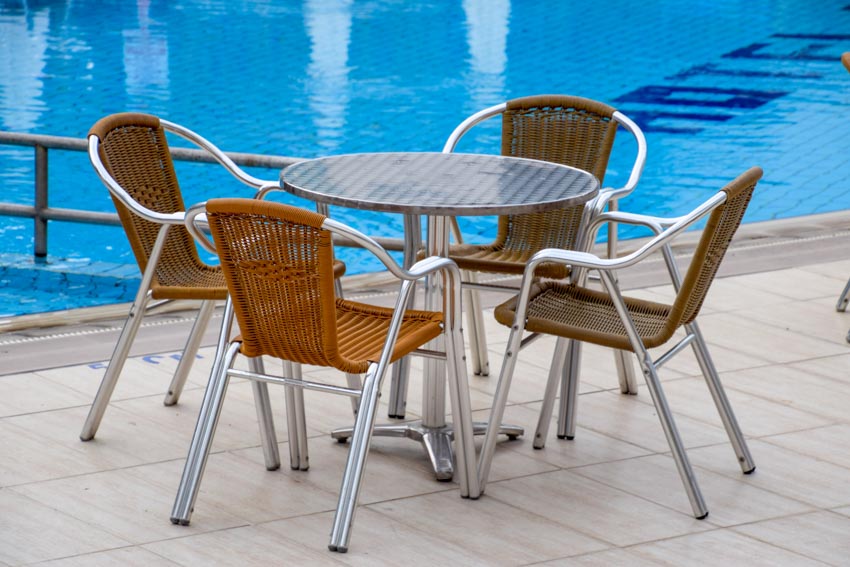 Metal chairs and table near outdoor pool