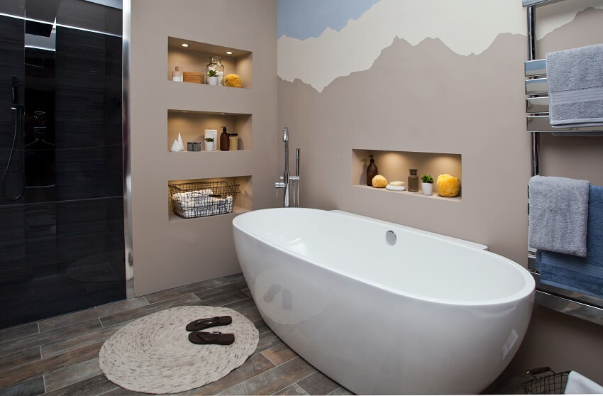 Bathroom interior with recessed wall shelves, towel racks, and bathtub