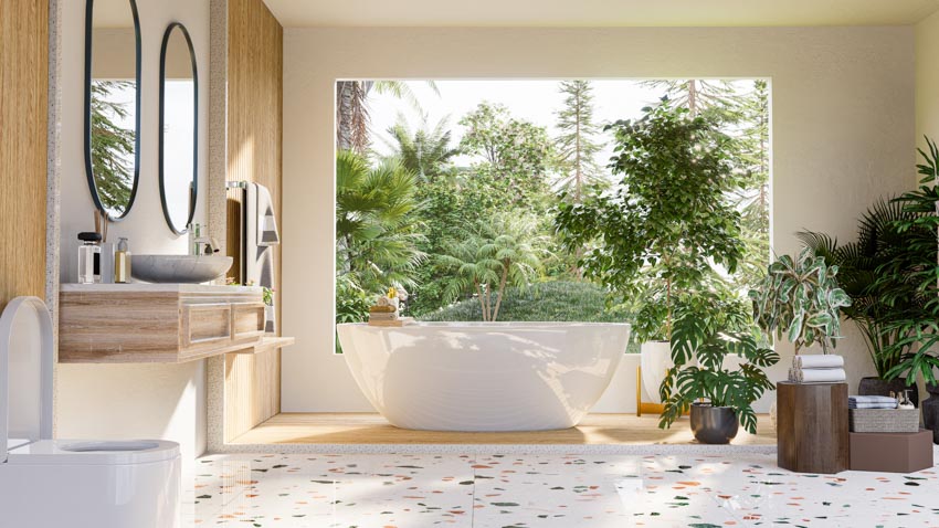 Bathroom with acrylic tub, mirror, sink, toilet, windows, and indoor plants
