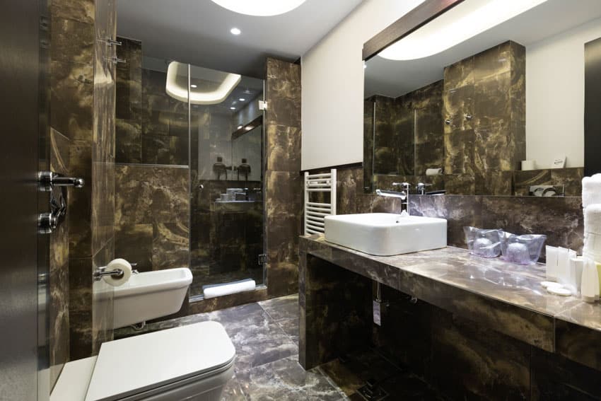 Bathroom with gold and black epoxy resin walls in dark finish