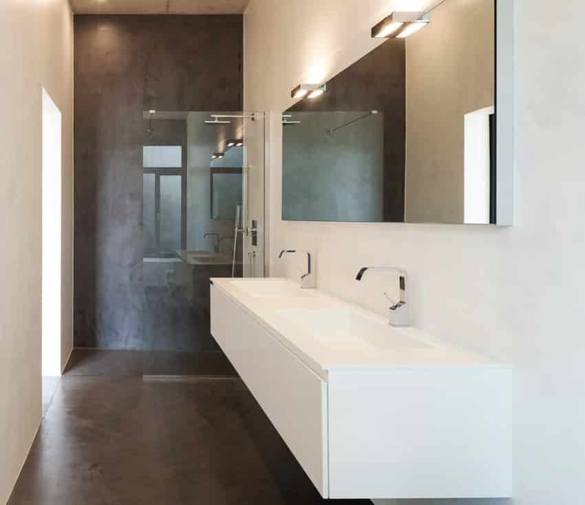 Minimalist bathroom with divider and epoxy coated walls in two tones