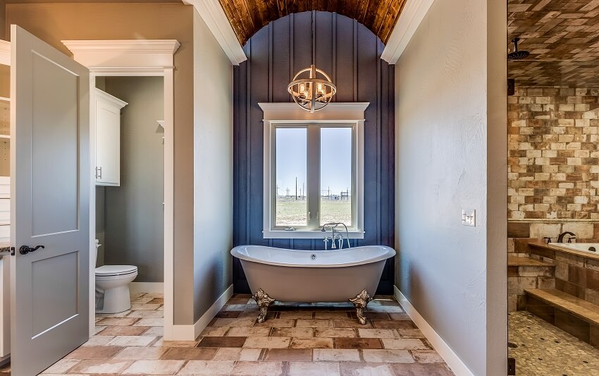 Bathroom with separated shower, toilet, and clawfoot tub in the middle
