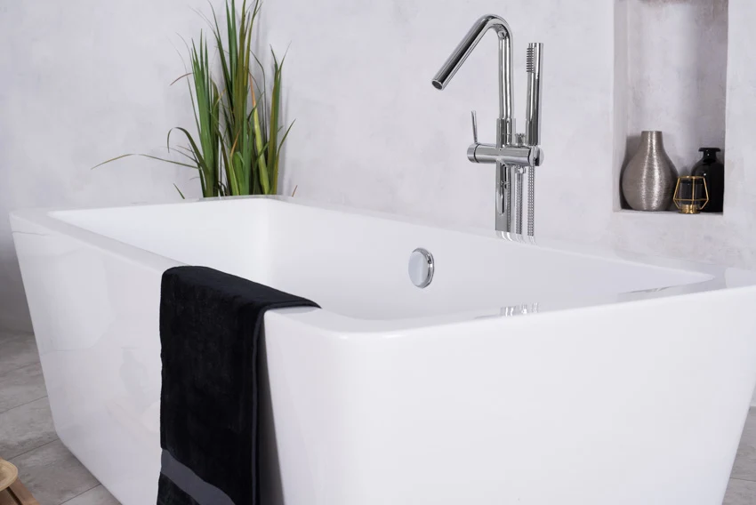 Bathtub with faucet, and drain
