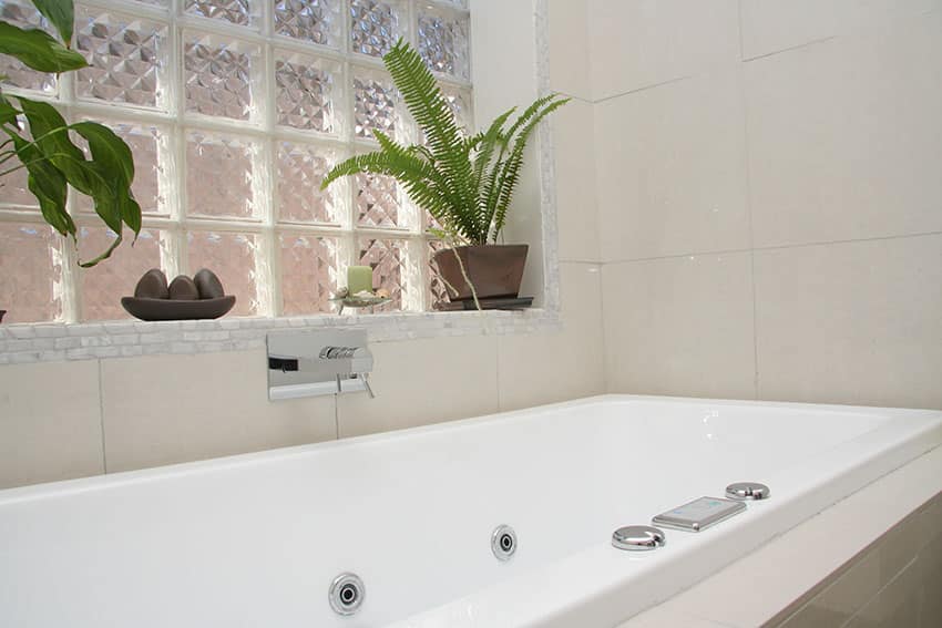 Bathtub area with modern glass block tiles