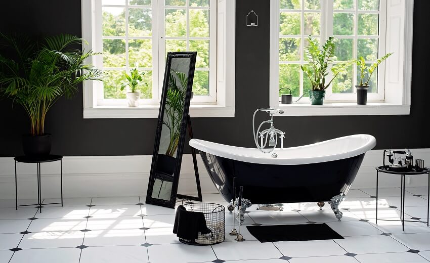 Bathroom with black and white porcelain tiles and black clawfoot tub