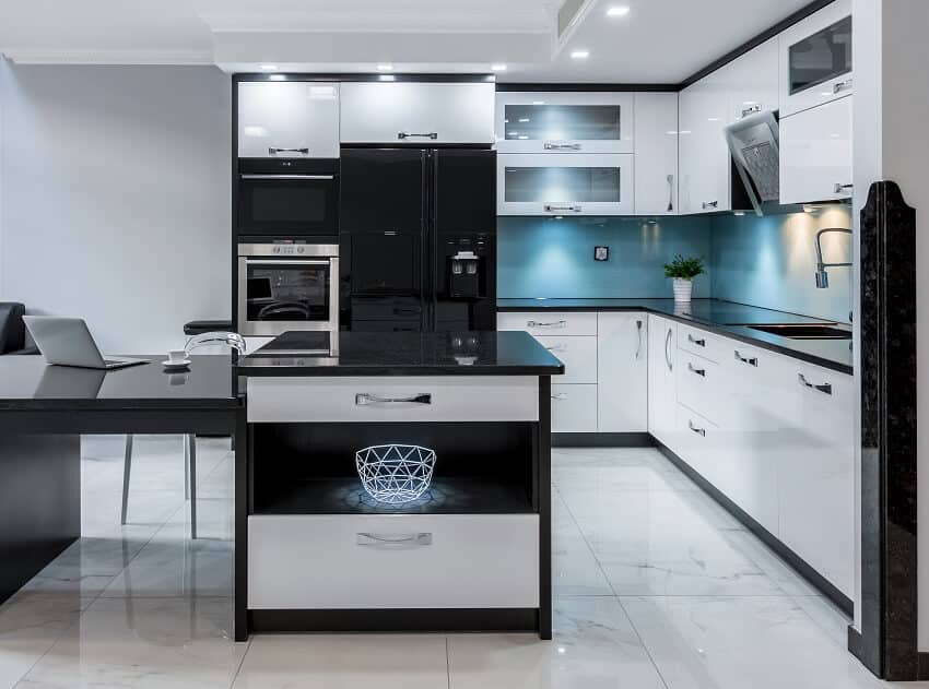 Black and white kitchen with blue backsplash, marble tile floor, and granite countertops