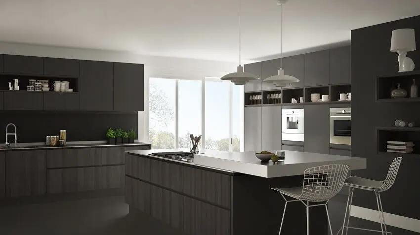 Black and white kitchen with pendant lights, island, and laminate cabinets