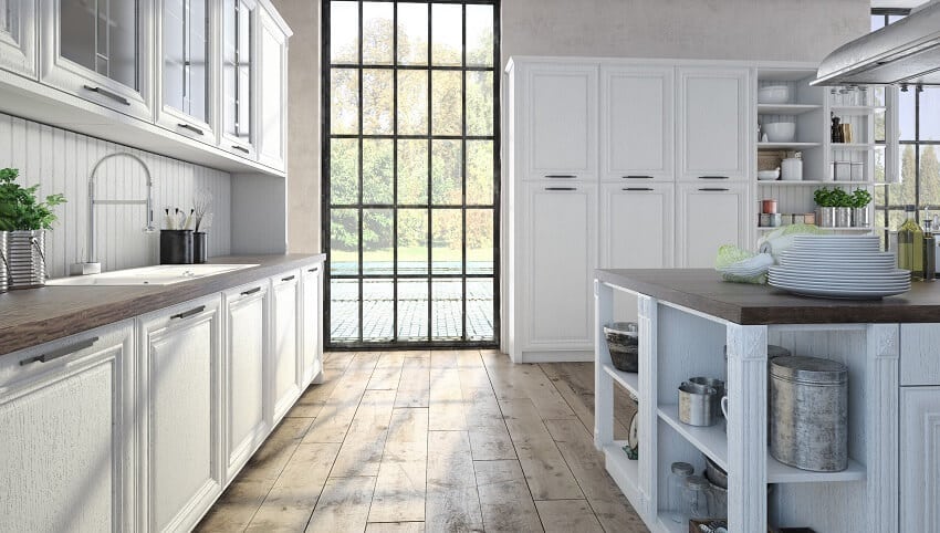 Bright kitchen with large window, wood floor, wood countertops and waterproof backsplash