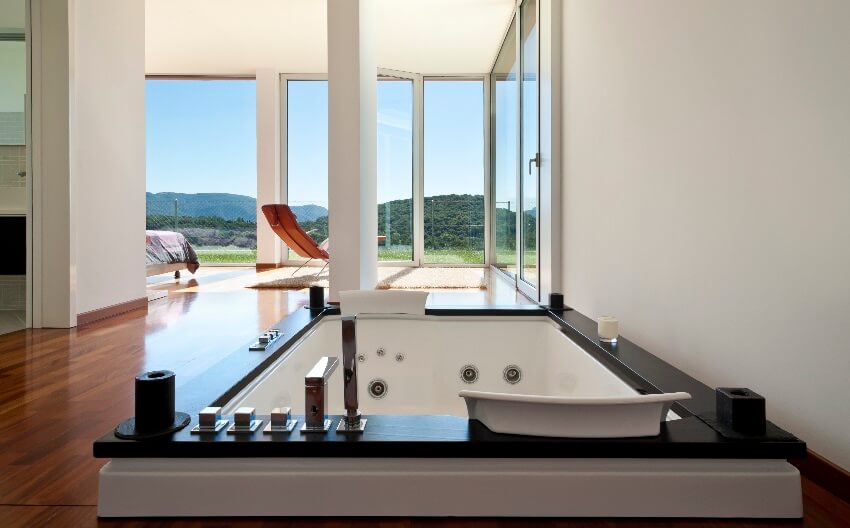 Bright master bedroom with jacuzzi tub, and panoramic windows
