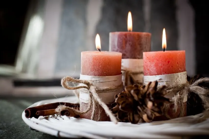 Burning exotic scented candles with birch decorations