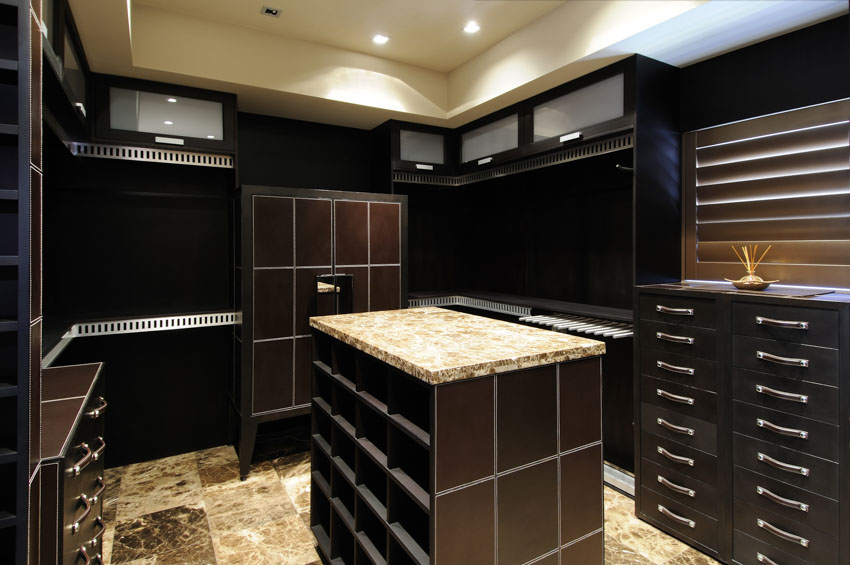 Closet with center island, black cabinets, and drawers