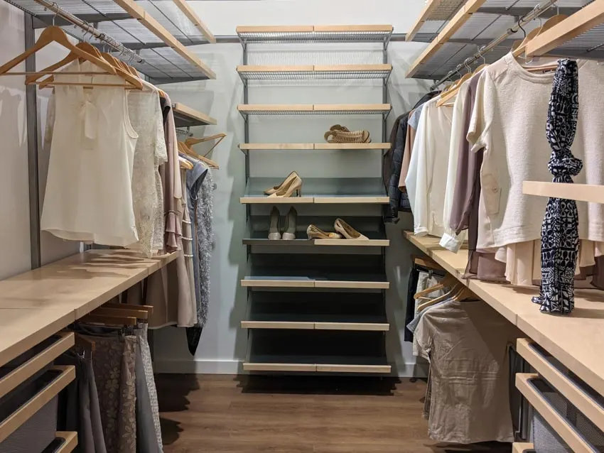 Closet with shoe island with nine shelves and wooden hangers