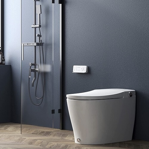 Dark grey wall behind integrated smart toilet, parquet floor, and shower in a bathroom