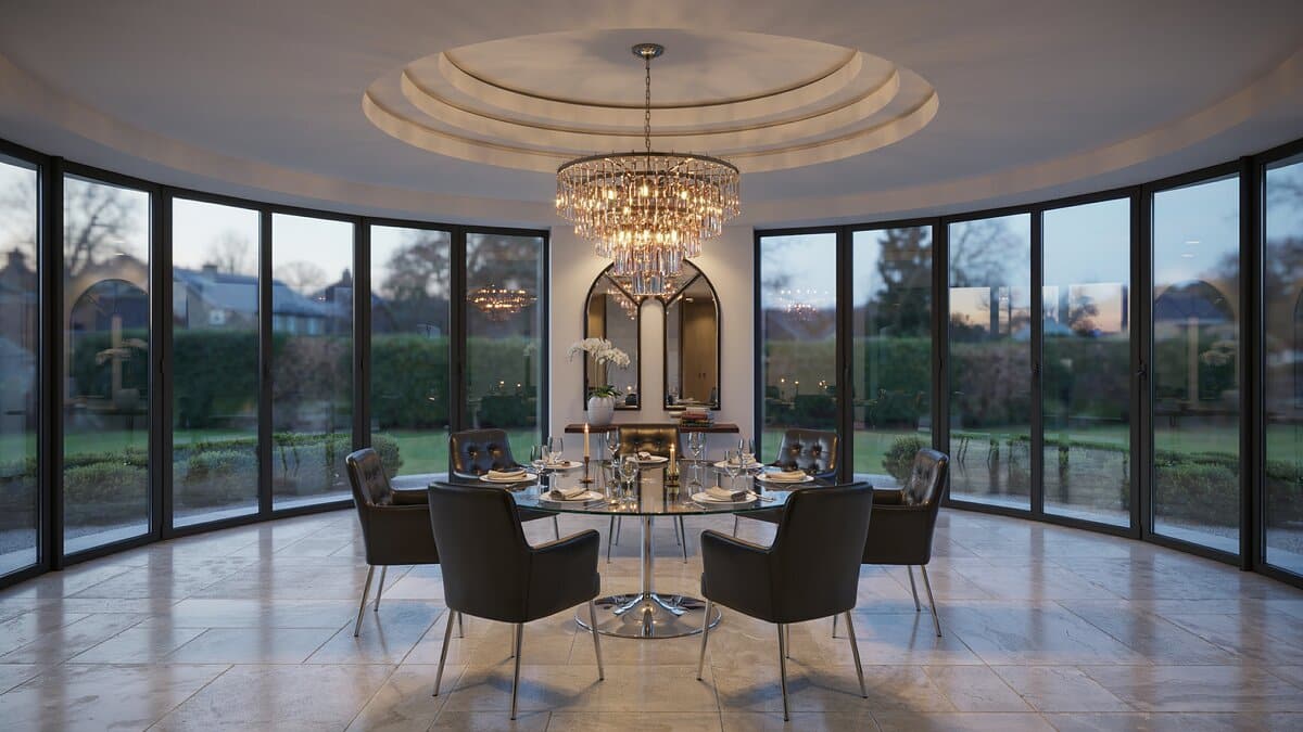 Round glass table and dark chairs under a domed ceiling with curved windows