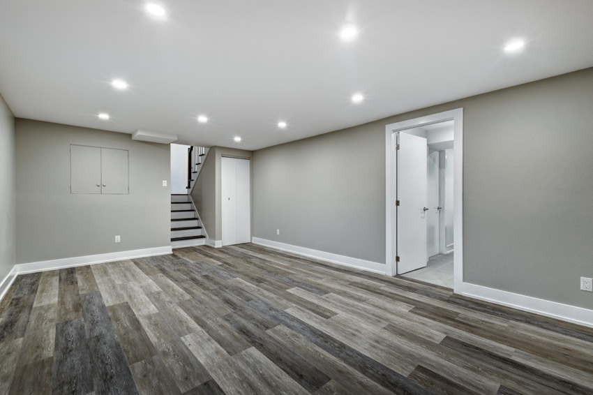 Empty basement with recessed lighting and wood flooring