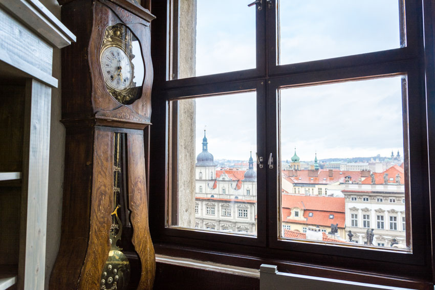 Antique clock beside window