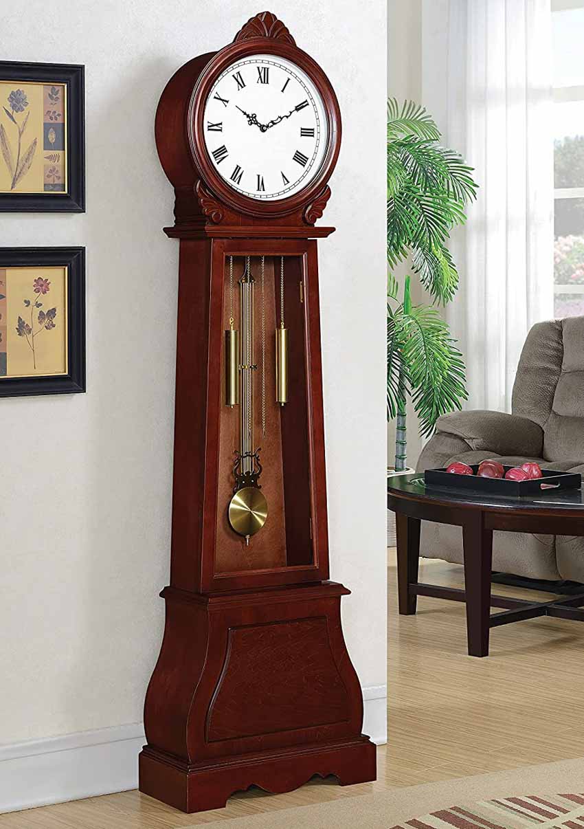 Grandfather clock in living room with chair and indoor plants
