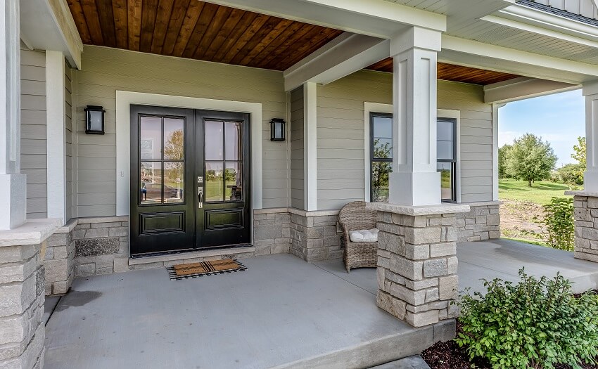 Home entrance with wood and stone siding