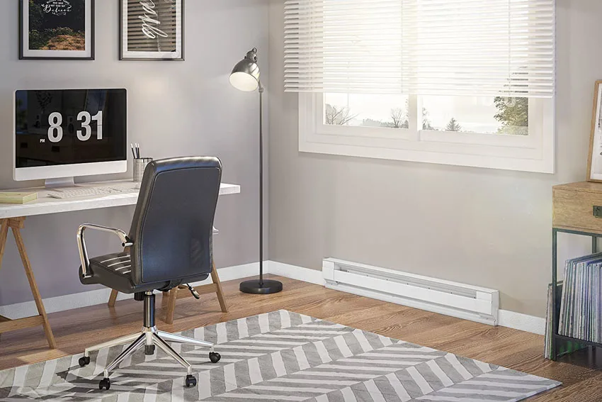 Home office with electric baseboard heater, wood floor, and floor lamp