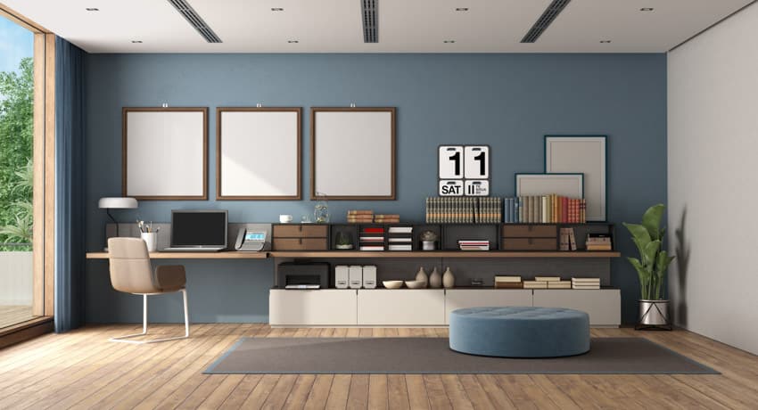 Home office with floating desk, wood floor, blue wall, chair, and window