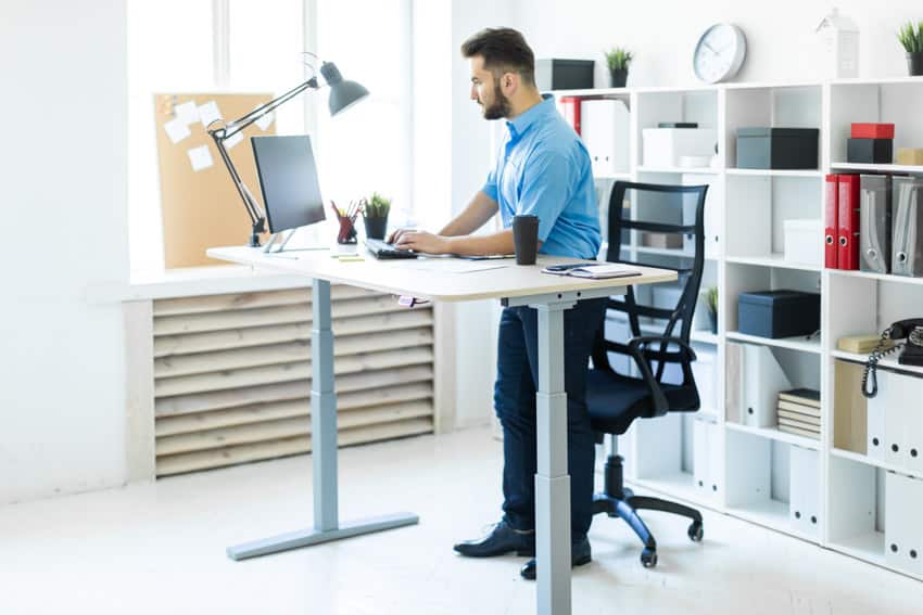 White standing desk and lamp
