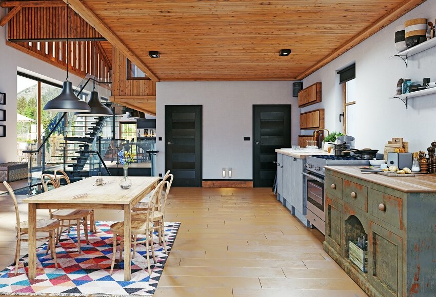 Kitchen and dining area with wood ceiling, tile floor, and pendant lights above wood dining table