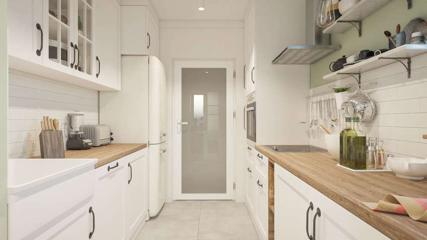 Kitchen with pale green wall and butcher block counters