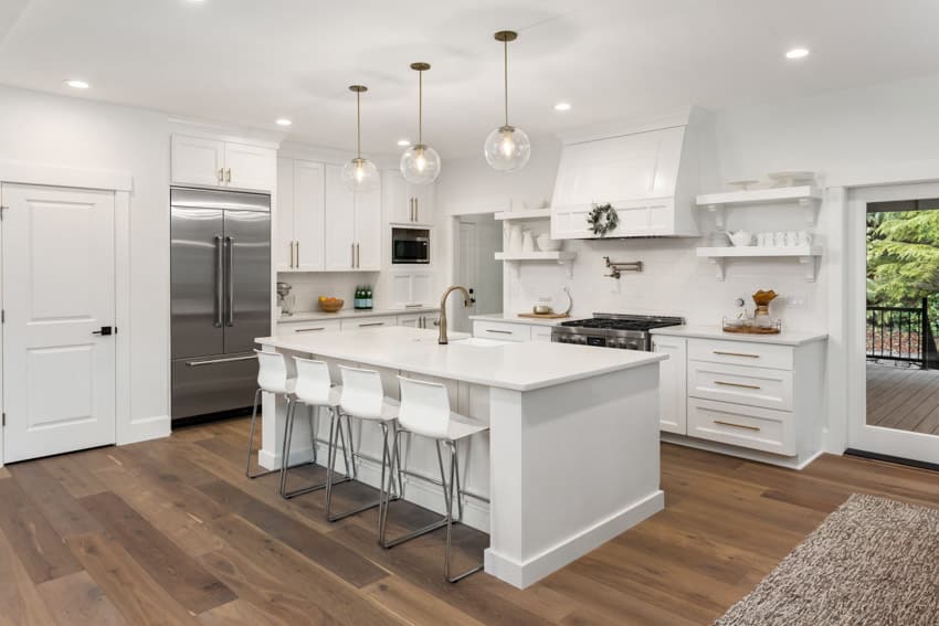 Kitchen with center island, wood floor, drawers, range hood, and recessed lighting fixtures
