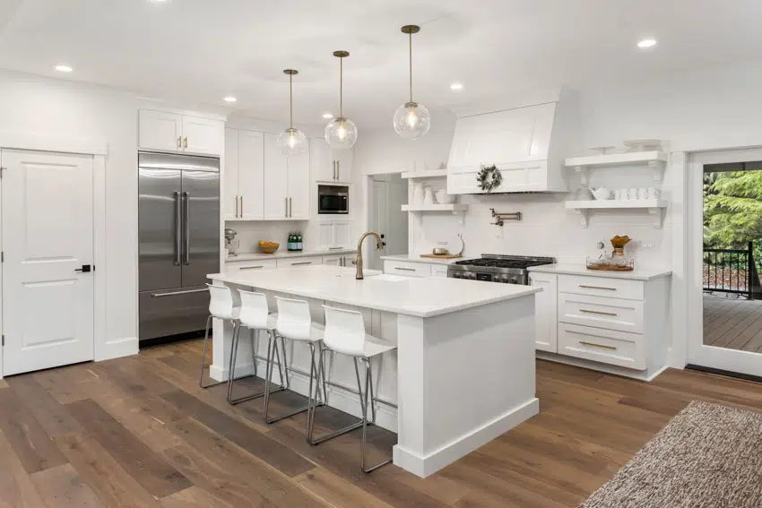 Kitchen With Center Island Thassos Marble Countertop Wood Floor Pendant Lights Drawers Range Hood And Recessed Lighting Fixtures Is .webp