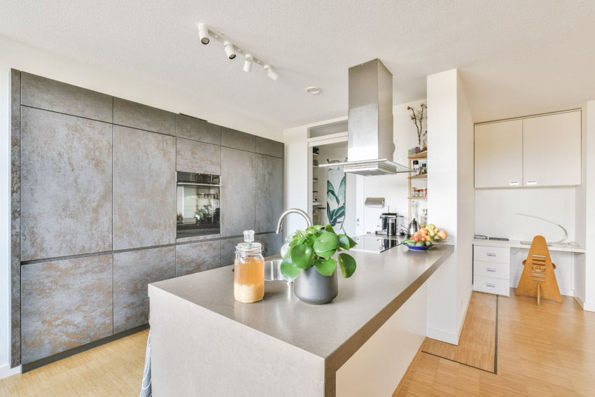 Kitchen with concrete distressed wall and track lighting fixtures