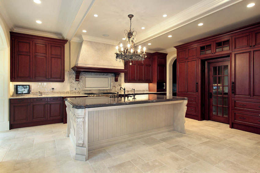 Kitchen with dark wood cabinets, center island, chandelier, and ceiling lights
