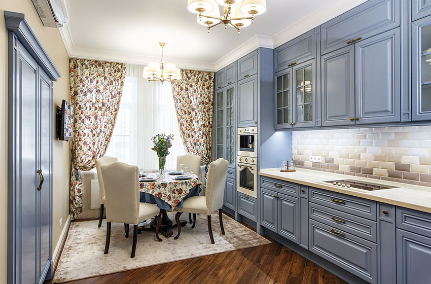 Kitchen with pattern curtains blue cabinets