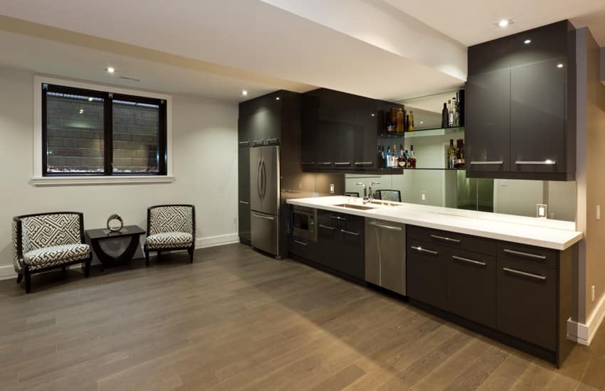 One wall kitchen with cabinets in dark wengue finish, chairs and side table