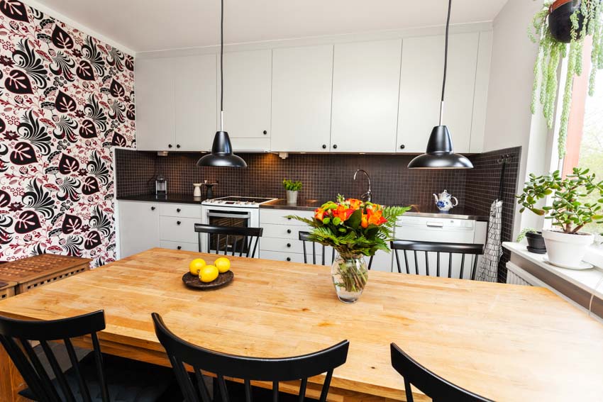 Kitchen with wallpaper covering one wall