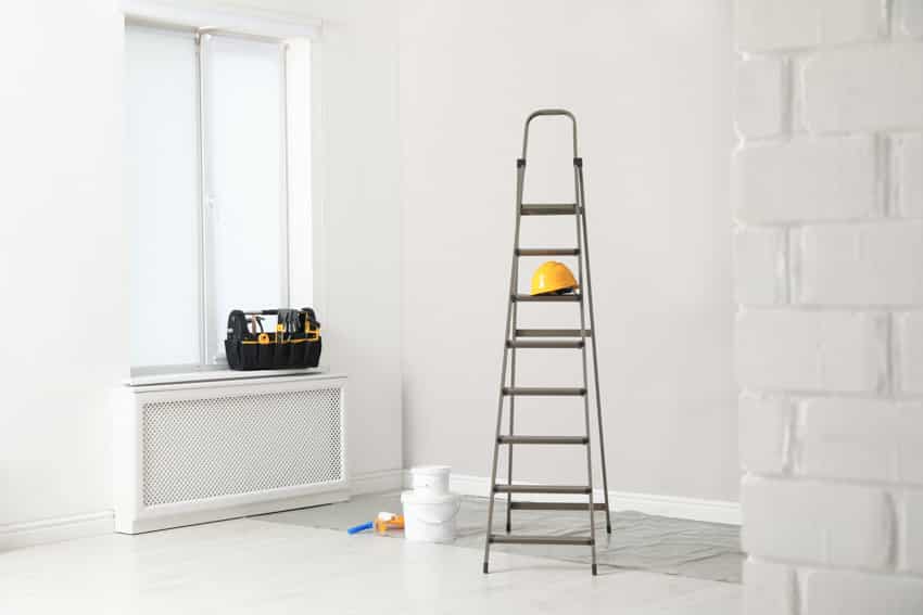 Ladder inside a room with white walls