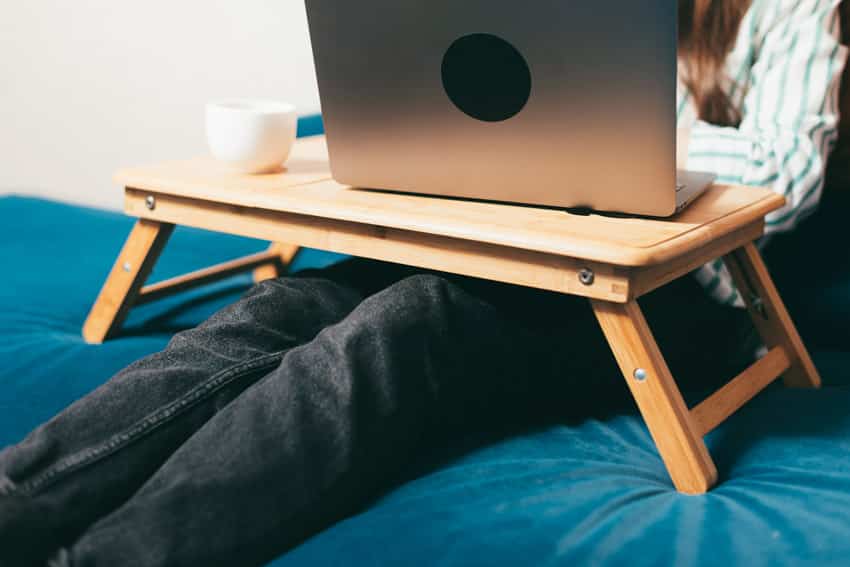 Lap desk with a laptop on it