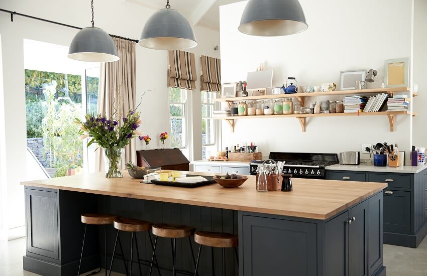 Large kitchen with floating shelves, pendant lights, island, and curtains with a rod pocket header