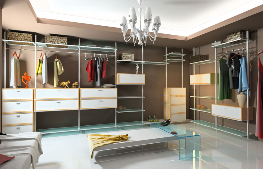 Luxury closet with center bench, drawers, and chandelier