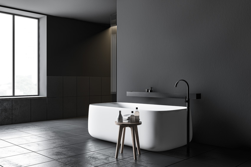 Minimalist bathroom with freestanding tub, and black finishes
