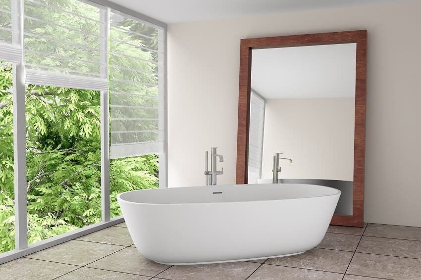 Modern bathroom with large mirror, freestanding bathtub, and tile floor